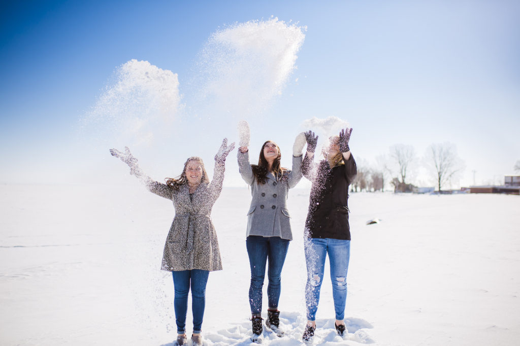 Girls tossing snow in the air