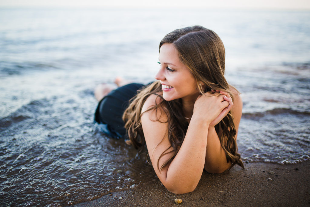 Girl laying in the water at the beach