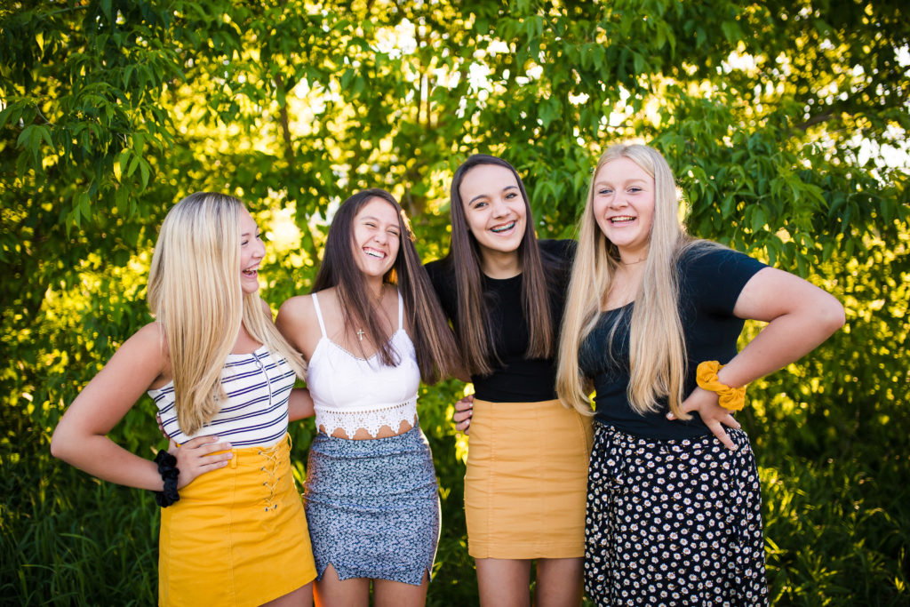 Girls standing by trees