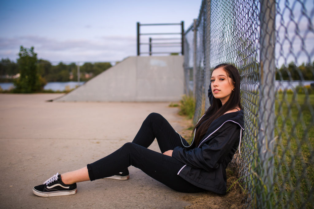 Skater girl sitting at skate park